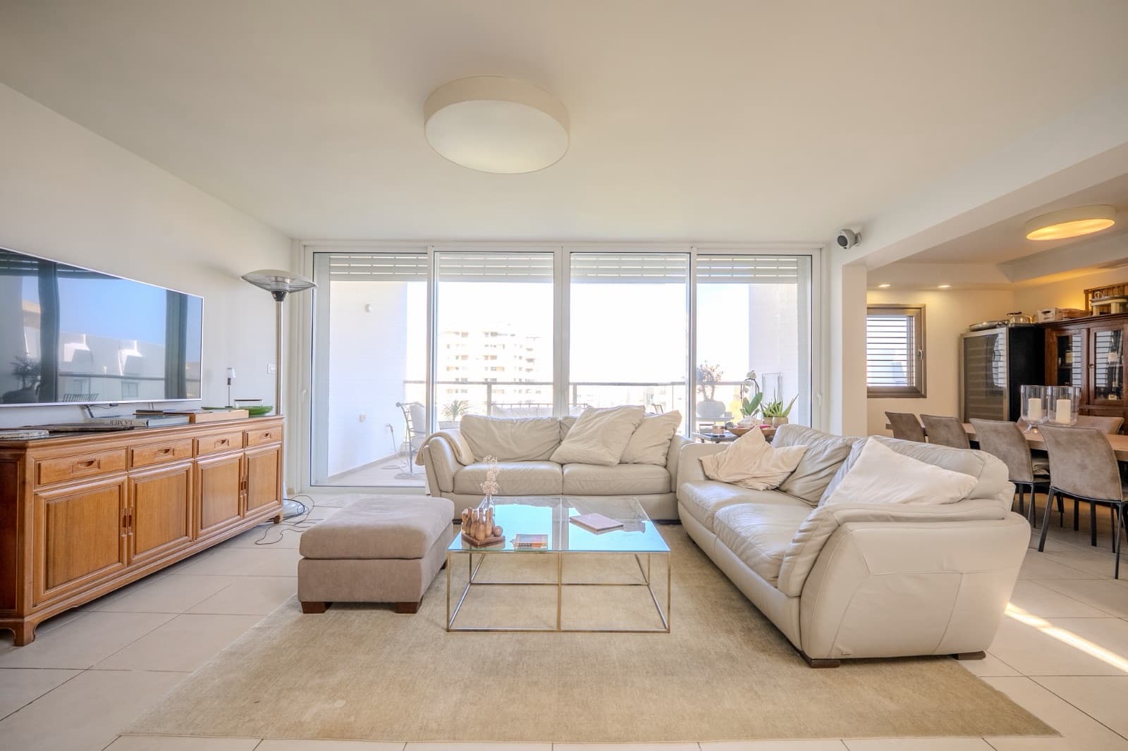 Living room with full-height glazing opening to the sun terrace