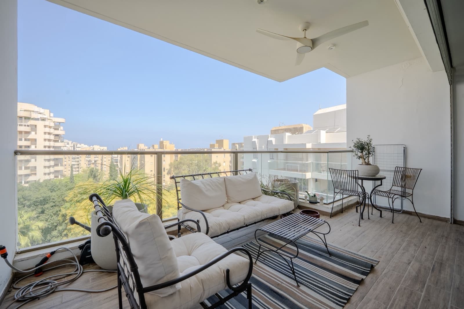 Sun terrace off the living level with lounge seating and a green outlook over the neighbourhood