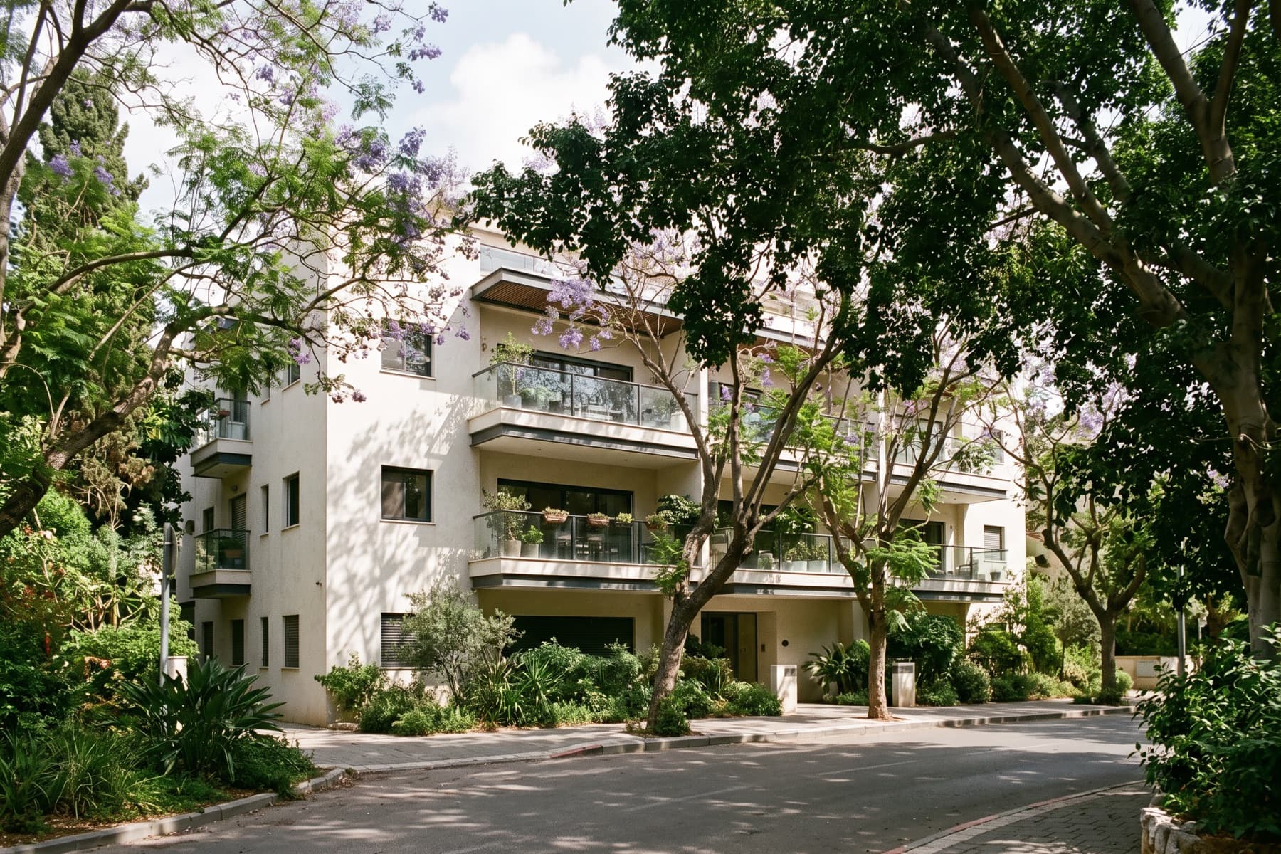 Ramat Aviv garden apartment: the building set behind mature trees