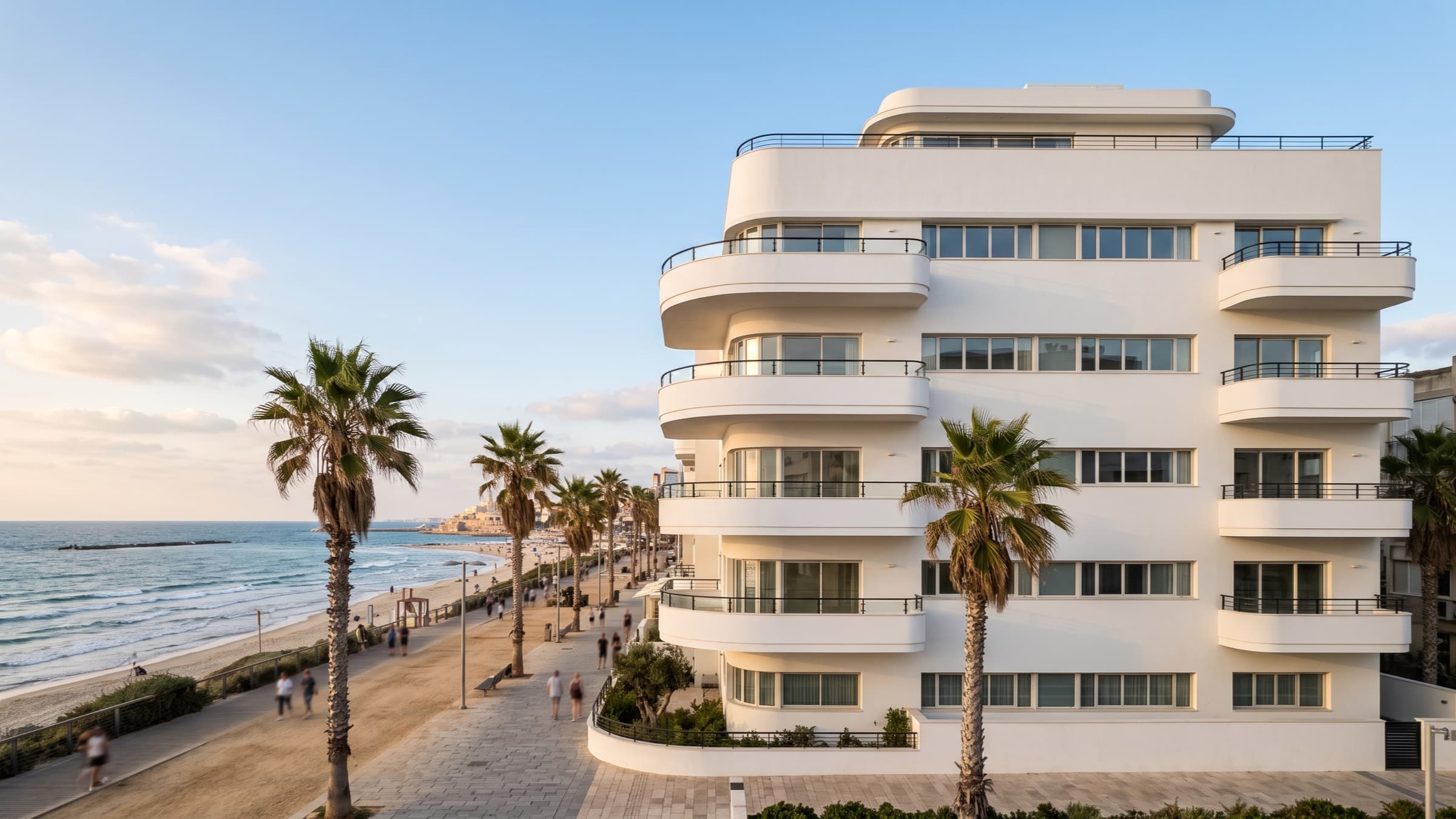 White modernist residential building on a Mediterranean seafront