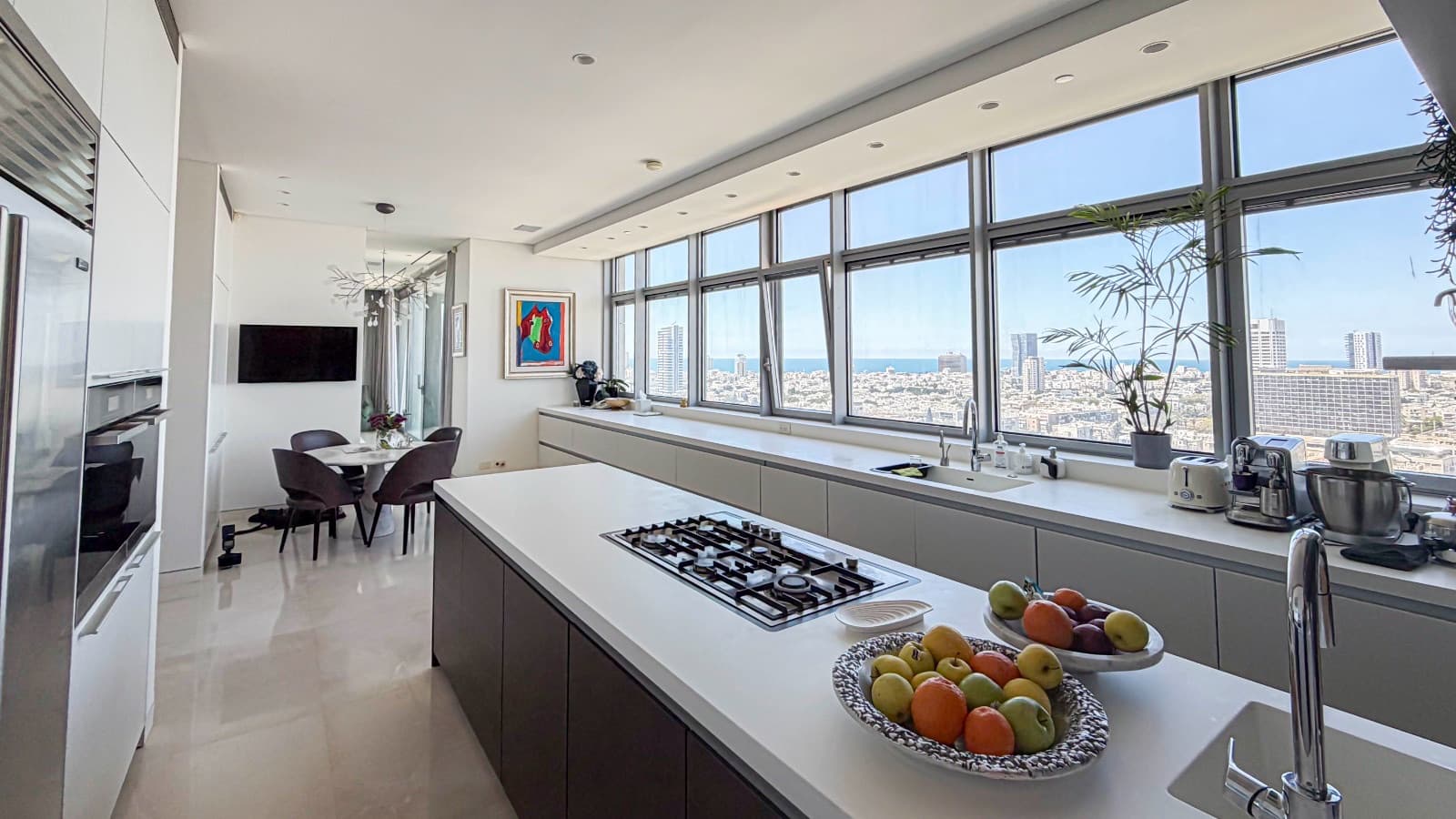 Kitchen along a continuous window band overlooking the city