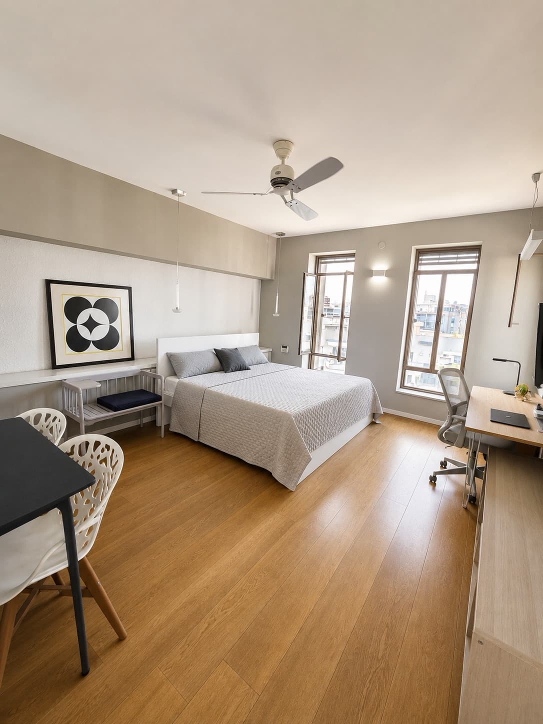 Principal bedroom in calm grey tones with a work corner and two windows