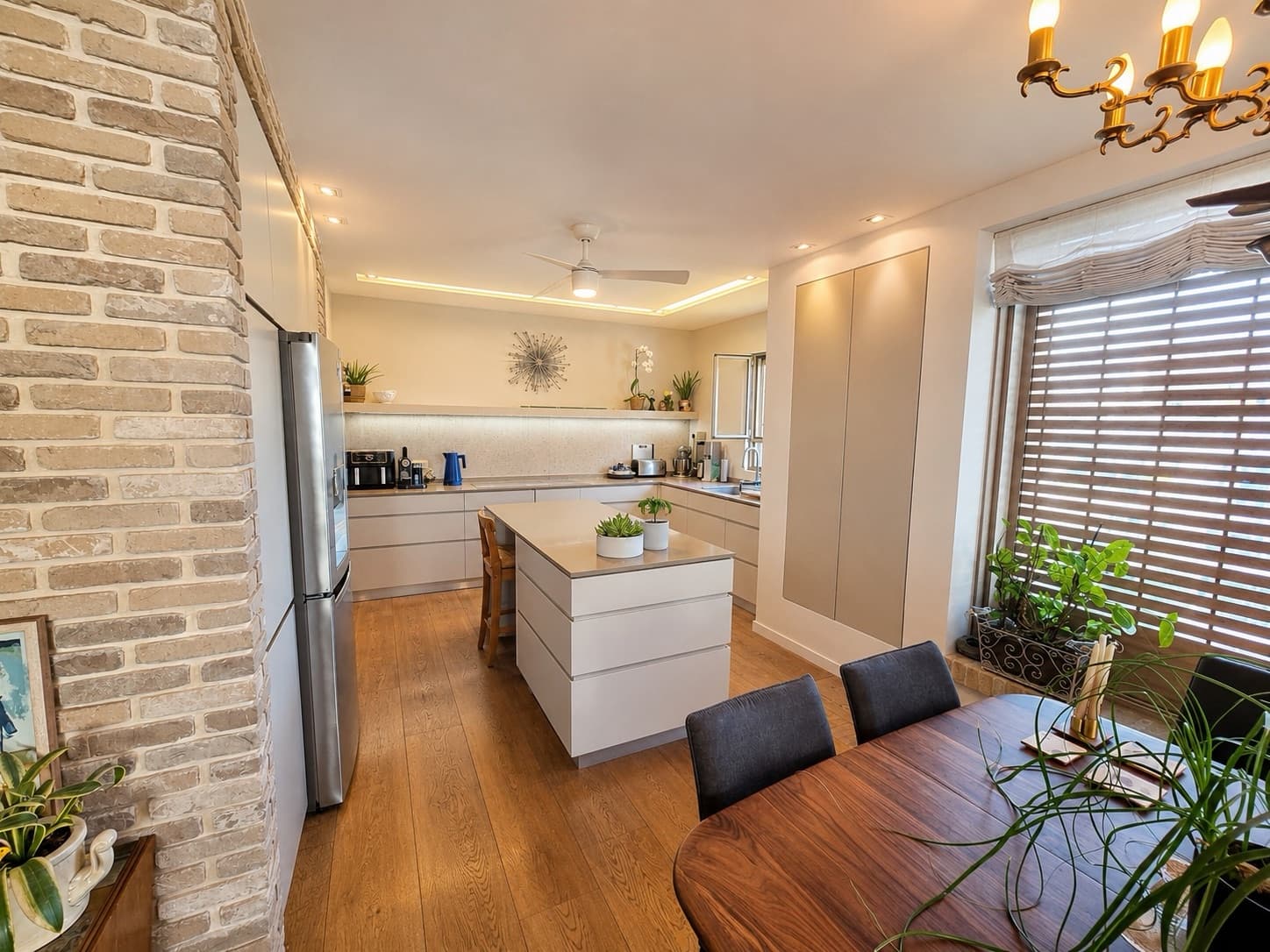 Chef's kitchen with central island beside the dining space