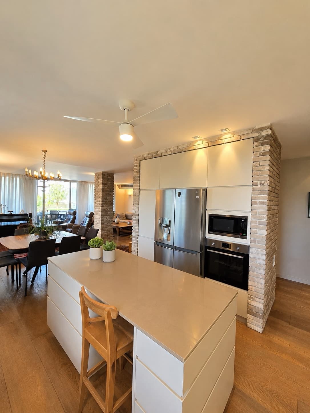 Kitchen island with stone worktop and integrated appliances