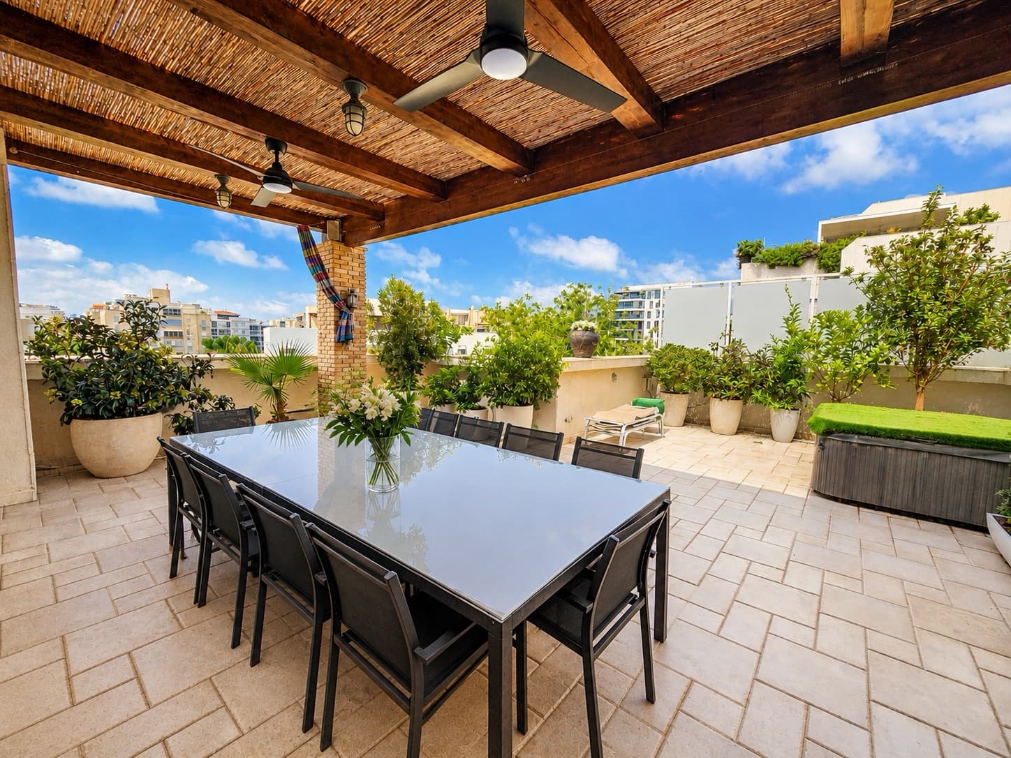 Main terrace with planted borders, sun lounger and private jacuzzi